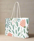 Oversized floral canvas tote styled with indoor plant for spring and summer vibes