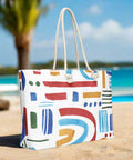 Oversized rainbow tote with rope handles styled for summer beach travel
