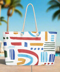 Bright abstract rainbow print tote by the pool with palm trees in the background