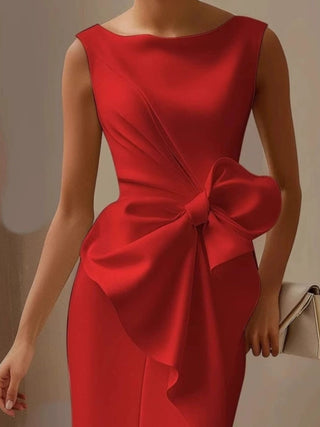 red occasion dress with oversized bow accent and sophisticated fitted silhouette