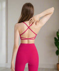 Back pose of pink cami with bright leggings