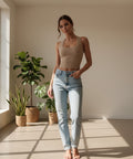 Women's beige ribbed square neck tank top styled with light wash jeans for an effortless everyday outfit.