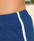 Detail of curved hem and contrast trim on athletic shorts