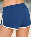 Side view of blue shorts with white piping and elastic waistband