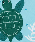 close up of sea turtle and ocean themed print on children's summer outfit