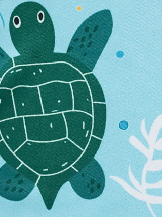 close up of sea turtle and ocean themed print on children's summer outfit