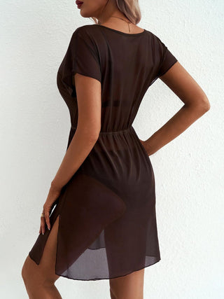 Woman wearing a brown sheer coverup against a white background