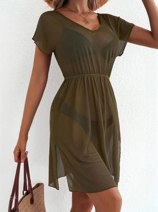 Woman wearing an olive green dress against a white background