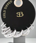 Gold and silver shiny hoop earring set on black display card