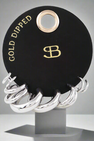 Gold and silver shiny hoop earring set on black display card