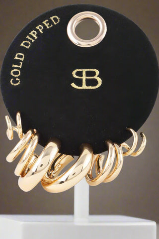 Close-up of gold-tone 1 inch hoop earrings from earring set