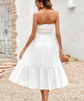 Back view of woman in white strapless smocked midi dress