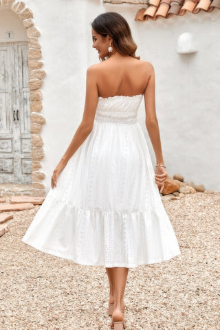 Back view of woman in white strapless smocked midi dress