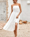 Woman wearing strapless smocked white midi dress with flowy skirt
