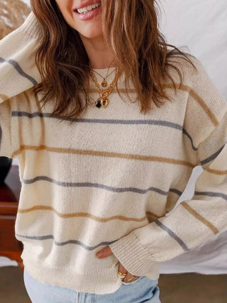 Casual spring outfit with cream striped drop shoulder sweater and light wash denim