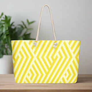 Front view of oversized yellow and white geometric print weekender tote bag with rope handles