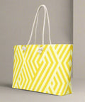 Side angle of yellow geometric oversized weekender tote with cream rope straps