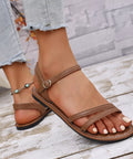 Tan comfort flat sandals with adjustable straps for beach vacations, travel, and everyday wear.
