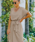 Side view of belted taupe mini dress with short sleeves