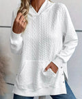 Woman wearing white textured knit hoodie sweater