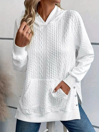 Woman wearing white textured knit hoodie sweater