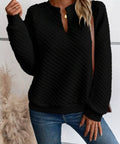 Model wearing a black textured notched raglan sleeve sweatshirt styled for everyday casual wear