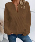 Front view of a brown textured notched raglan sleeve sweatshirt styled casually with jeans