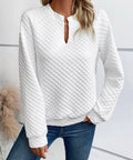 Front view of a white textured notched raglan sleeve sweatshirt for women
