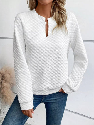 Front view of a white textured notched raglan sleeve sweatshirt for women