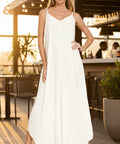 Woman wearing a cream textured rayon cami maxi dress with side pockets