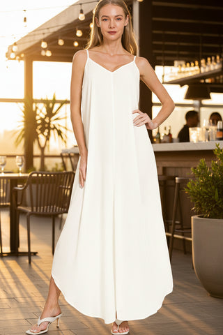 Woman wearing a cream textured rayon cami maxi dress with side pockets