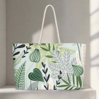 Oversized tote bag with tropical leaf design styled on a modern wood countertop