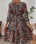 Back view of 3/4 sleeve floral mini dress with gathered waistline