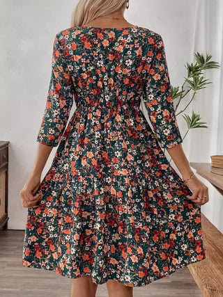 Back view of 3/4 sleeve floral mini dress with gathered waistline