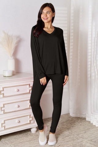 Model wearing a black V-neck long sleeve lounge set with matching pants, styled for casual comfort.