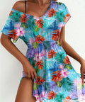 Woman wearing a colorful floral dress against a white background