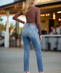 Back view of straight leg mid rise jeans in light vintage wash