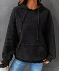 Close-up of black waffle knit hoodie texture