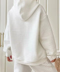 Back view of white waffle knit hoodie with hood detail