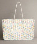 Pastel geometric weekender tote bag against grey backdrop