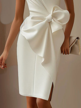 white wedding guest dress featuring oversized bow detail and elegant fitted silhouette