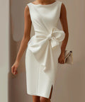 woman wearing elegant white bow detail midi dress with side slit and sleeveless silhouette