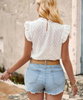 Back view showing crochet texture and cap sleeves of white knit top