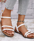 White comfort flat sandals with adjustable ankle straps for summer outfits, vacations, and everyday wear.