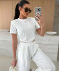 woman wearing white wide leg pants set styled for vacation and travel