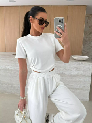 woman wearing white wide leg pants set styled for vacation and travel