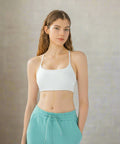 Woman wearing white cami with fitted waist leggings
