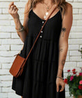 Casual black sun dress with wide straps, accessorized with crossbody bag
