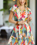 Full body image of women’s colorful flowy mini dress, short sleeves, and cinched waist