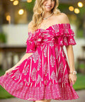 Full body view of pink off-shoulder dress with ruffle sleeves, lightweight fabric
